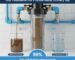 An original, high-angle image of a robust whole house sediment water filter unit, prominently installed at the main water inlet of a home, showcasing comprehensive protection offered by a pp cotton household water purifier company.