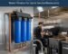 A high-flow commercial water filtration system installed in a busy quick service restaurant kitchen. yourwatergood provides specialized sediment and chlorine removal to ensure consistent beverage taste and equipment protection.