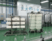 Advanced water filtration for food and beverage industry shown in a high-tech bottling plant with stainless steel tanks and automated conveyors.